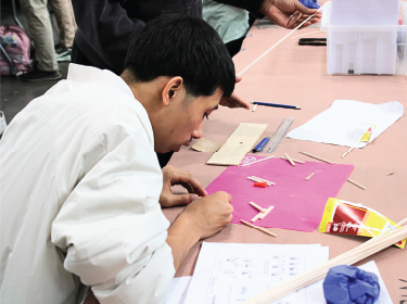 student working on bridge